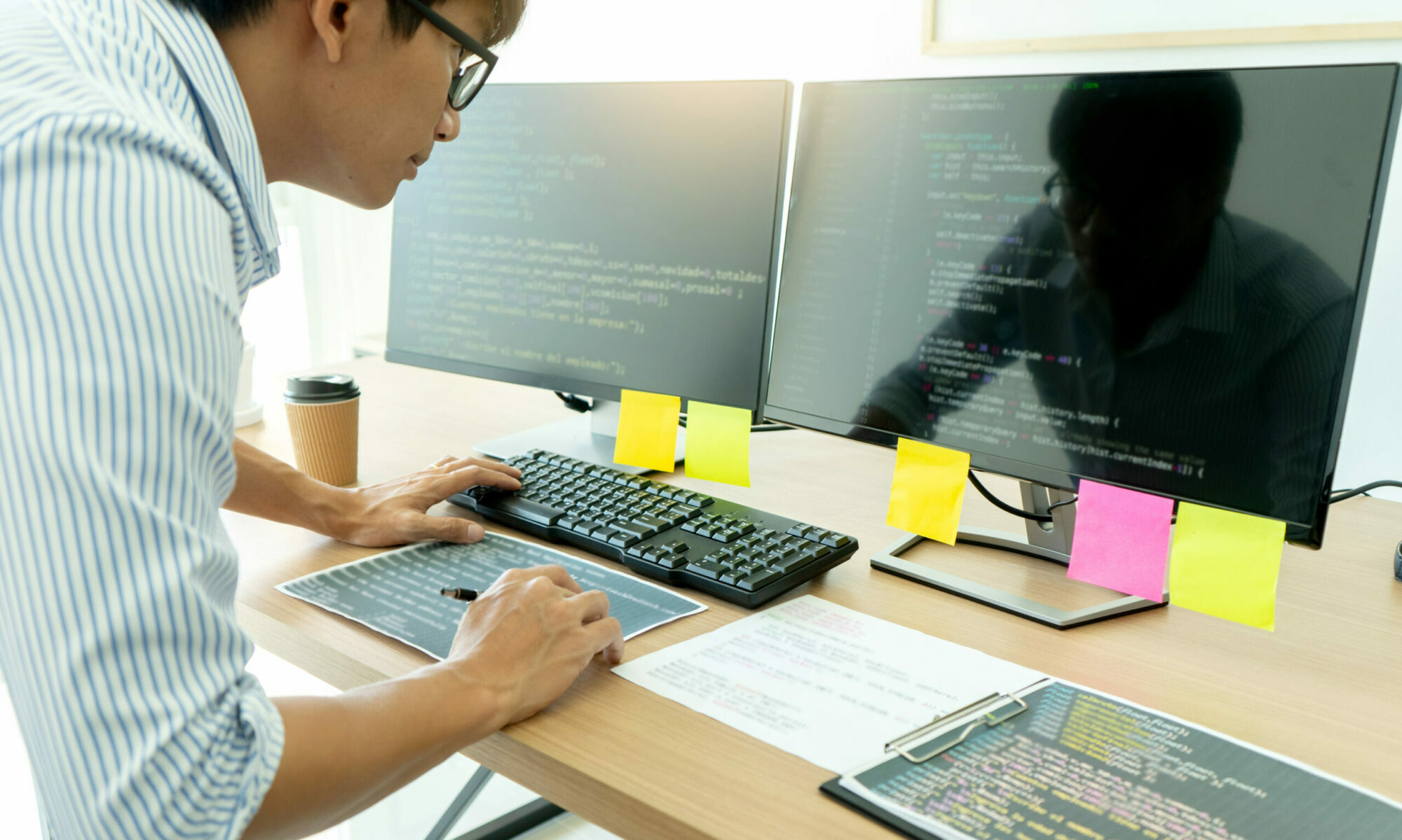 programmer work with Developing programming and coding technologies. Programmer working with software on many computer on the table in office. concept Website design
